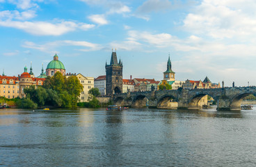 Charles Bridge in Prague in the Czech Republic. Old Town Bridge Tower. The Mill peninsula.Catholic church of St. Franciszek of Serafin. Sculptures on the Charles Bridge.  The Vltava River