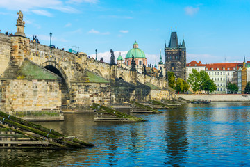 Charles Bridge in Prague in the Czech Republic. Old Town Bridge Tower. The Mill peninsula. Sculptures on the Charles Bridge.  The Vltava River