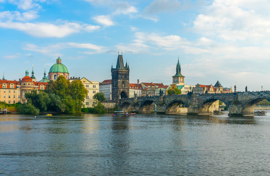Charles Bridge in Prague in the Czech Republic. Old Town Bridge Tower. The Mill peninsula.Catholic church of St. Franciszek of Serafin. Sculptures on the Charles Bridge.  The Vltava River