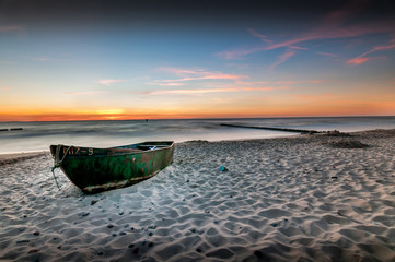 Boat on the beach, View after sunset. Long exposure, smooth sea.