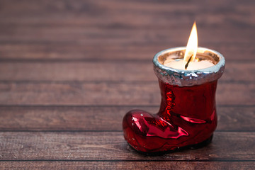 Christmas candle form the boots of Santa Claus