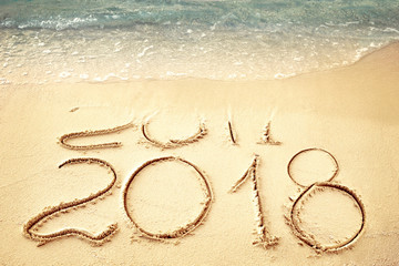 Fototapeta na wymiar New Year 2018 replace 2017 on sea beach summer, New Year 2017 is coming concept. Closeup.