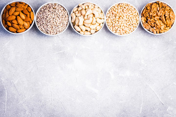 Nuts and seeds mix on concrete background. Top view, space for text.