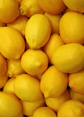 Heap of Vibrant Yellow Lemons, Vertical Photo for Background or Banner 