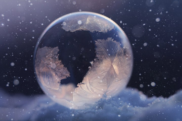 Frozen soap bubble in snow