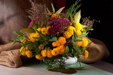 autumn bouquet of yellow flowers on blurred background