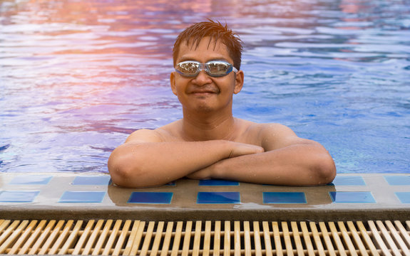 Portrait Of Asian Smiling Man Swimming At Pool.