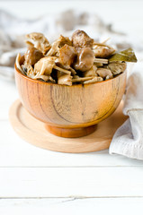 Marinated mushrooms (honey agarics) in a wooden bowl