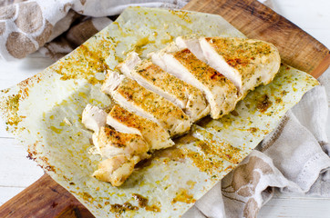Fried chicken breast on a chopping board