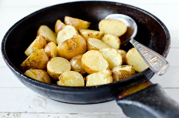 Fried young potatoes in a frying pan