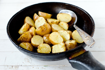Fried young potatoes in a frying pan