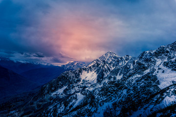 Dramatic sky above rugged mountains at dusk
