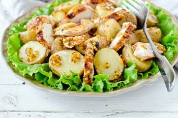 Warm salad of chicken and potatoes with mustard dressing