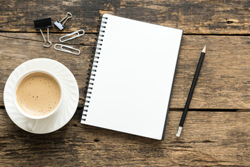 Empty notebook and coffee on  wooden table