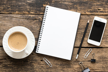 Empty notebook and coffee on  wooden table