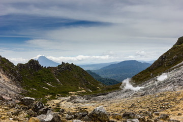 Fototapeta na wymiar Volcanic fumaroles emitting Sulphur and steam on a bleak high volcano (Mount Sibayak)