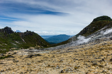Volcanic fumaroles emitting Sulphur and steam on a bleak high volcano