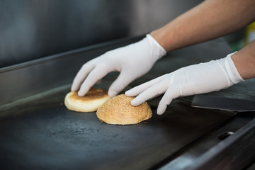 Preparation of a delicious juicy burger close-up. All the ingredients are made on the grill
