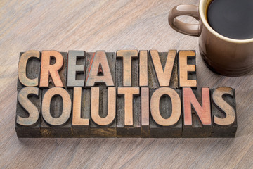 creative solutions word abstract in wood type