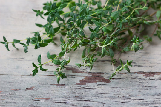 Thyme on a wooden background.