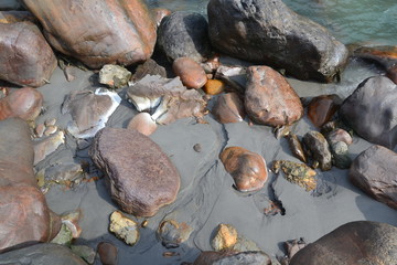 bold stones in the sand by the river