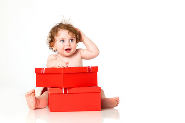 Cute Baby Santa with red gift boxes