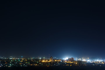 Fototapeta premium The bright lights of the city streets in the background of the night sky
