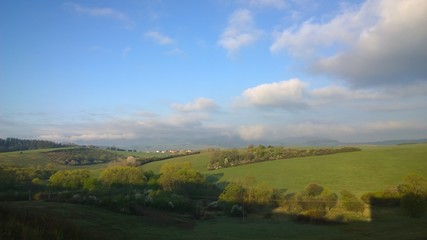Obraz premium Clouds and sunrays over the meadow. Slovakia