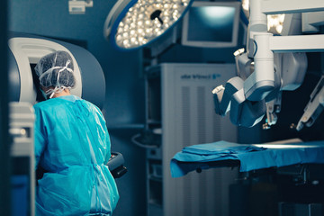 Surgical room in hospital with robotic technology equipment, machine arm surgeon in futuristic operation room. Minimal invasive surgical inoovation, medical robot surgery with 3D view endoscopy