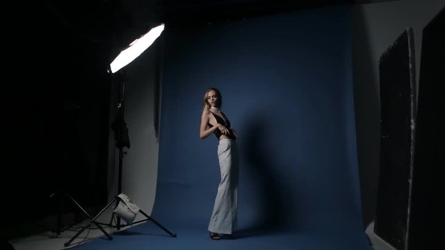 Model with European features pose for a photographer in the studio.