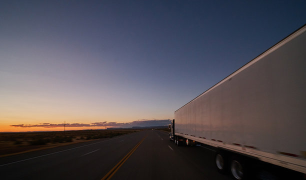 large freight truck on highway at dusk
