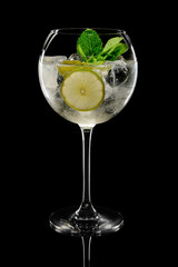 Lemon cocktail with a sparkling wine with ice cubes in wine glass