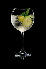 Lemon cocktail with a sparkling wine with ice cubes in wine glass