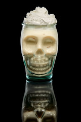 Scull glass with Coconut cream and rum cocktail. Tiki pot.