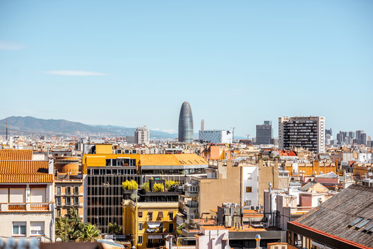 Skyline view with Agbar tower, residential buildings and mountains on the background in Barcelona city