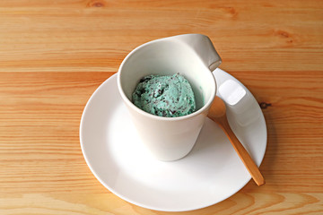 One Cup of Mint Chocolate Chip Ice-cream Served on Brown Wooden Table 