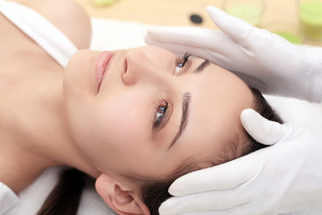 Obraz na płótnie Canvas Woman under professional facial massage in beauty spa