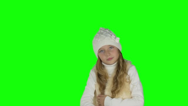Young caucasian girl thinking and looking down. Girl show thumbs up gestures. Waist up portret. Keyed clip. Solid green background instead alpha channel.