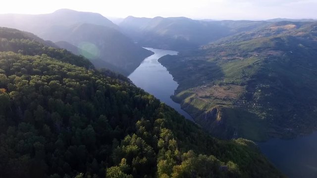 Banjska stena viewpoint in Tara National Park, Serbia. Beautiful landscape of the Drina river canyon and its green cliffs, and blue Perucac Lake. Blue sky reflecting its color in the lake.