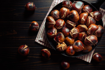 chestnuts in a pan on dark wooden background