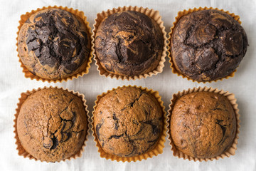 six tasty freshly baked vanilla-chocolate muffins, top view