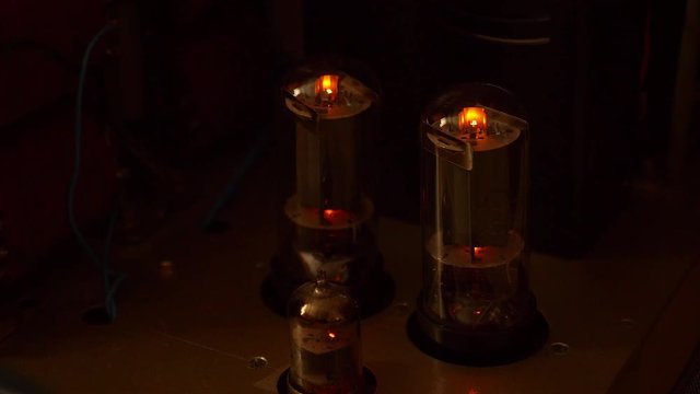 Turning on power tube amplifier. Vintage retro DIY tube amp. Hi-Fi audio system. Audiophile locer music device. Orange lights and blue lights.