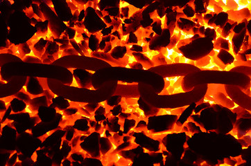 The glowing chain lies on the hot coal anthracite.