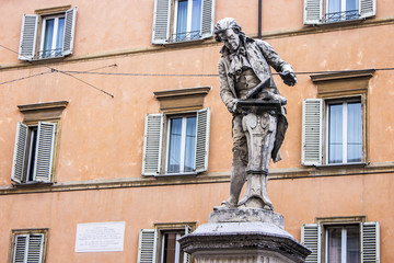 Obraz premium Statue of a man with books in Bologna, northern Italy