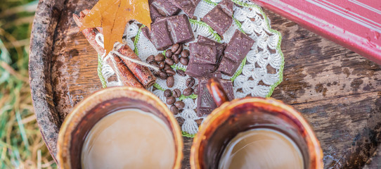 Two cups of coffee near a close book