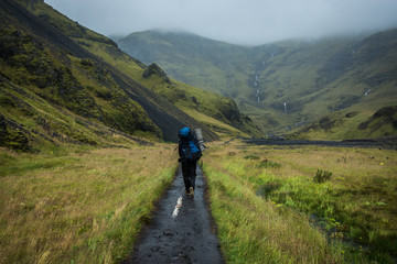 Fototapeta na wymiar Hiking with backpack at Iceland green mountains