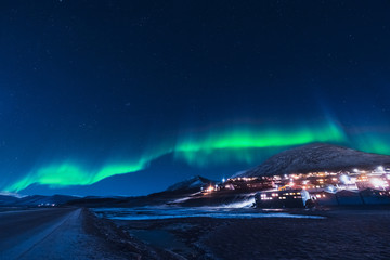 The polar arctic Northern lights aurora borealis sky star in Norway Svalbard in Longyearbyen the moon mountains - obrazy, fototapety, plakaty