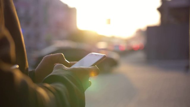 businessman uses modern mobile phone on the street