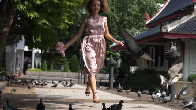 Young Woman In Dress Running In Park With Flying Pigeons. Slow Motion. HD, 1920x1080. 