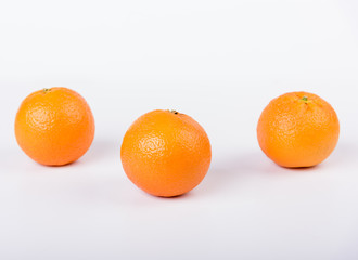 Fresh oranges over a white background